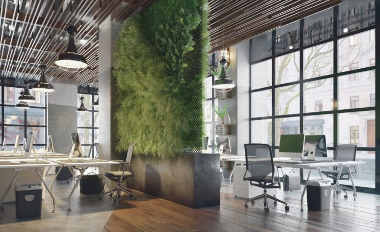 Ein modernes, begrüntes Architekturbüro in Mülheim an der Ruhr mit Pflanzenwänden und Design-Möbeln, exemplarisch für die spezialisierte Pflege von Green Offices und Kreativ-Agenturen durch UCT.